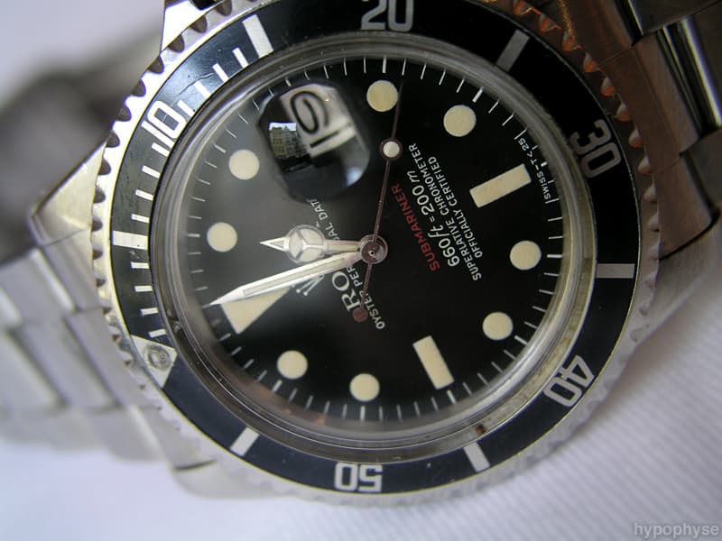 Rolex Submariner Date 1680 “Red Sub”: “Submariner” printed in red above a feet-first “660ft=200m” depth rating and four-line chronometer text; date window with Cyclops. · Photo: hypo.physe (Flickr) · CC BY-SA 2.0 · https://creativecommons.org/licenses/by-sa/2.0/ · Source: https://www.flickr.com/photos/hypophyse/4279725285/