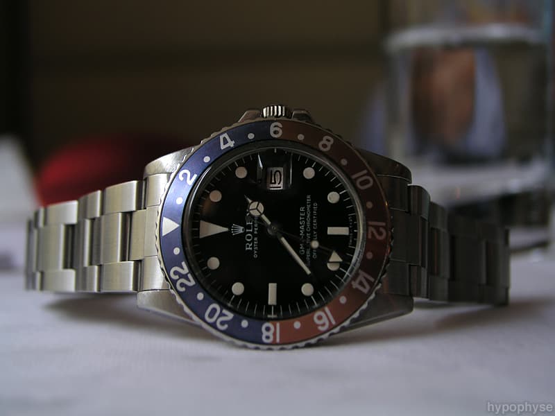 Rolex GMT-Master 1675 with a matte black dial, white print, red-and-blue “Pepsi” 24-hour bezel, date window and red GMT hand. · Photo: hypo.physe (Flickr) · CC BY-SA 2.0 · https://creativecommons.org/licenses/by-sa/2.0/ · Source: https://www.flickr.com/photos/hypophyse/4280464268/