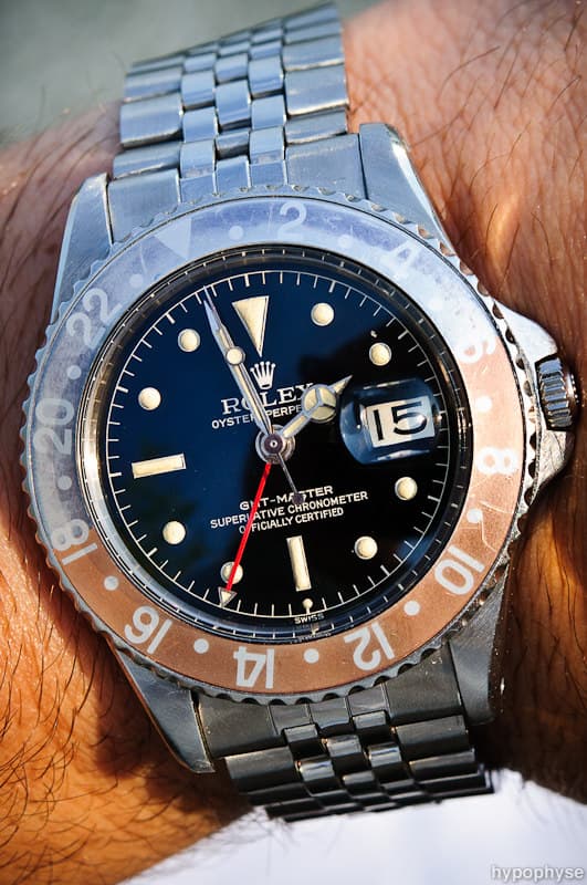 Rolex GMT-Master 1675 (owner's title “PCG”, pointed crown guards) with a glossy black gilt dial, gilt “GMT-Master” and chronometer text, faded Pepsi bezel, Jubilee bracelet. · Photo: hypo.physe (Flickr) · CC BY-SA 2.0 · https://creativecommons.org/licenses/by-sa/2.0/ · Source: https://www.flickr.com/photos/hypophyse/4802737140/