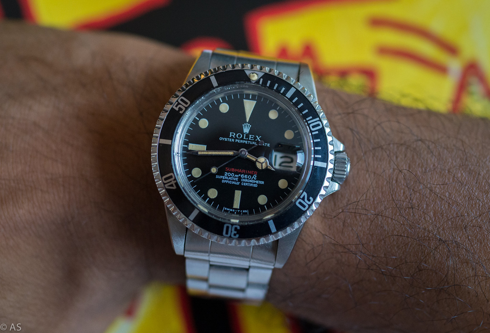 Rolex Submariner Date 1680 on the wrist, titled “Red Mark 1” by the owner: red “Submariner” line with meters-first “200m=660ft” and chronometer text, date with Cyclops, Oyster bracelet. Mark not checked. · Photo: section215 (Flickr) · CC BY 2.0 · https://creativecommons.org/licenses/by/2.0/ · Source: https://www.flickr.com/photos/babyknight/15646852533/